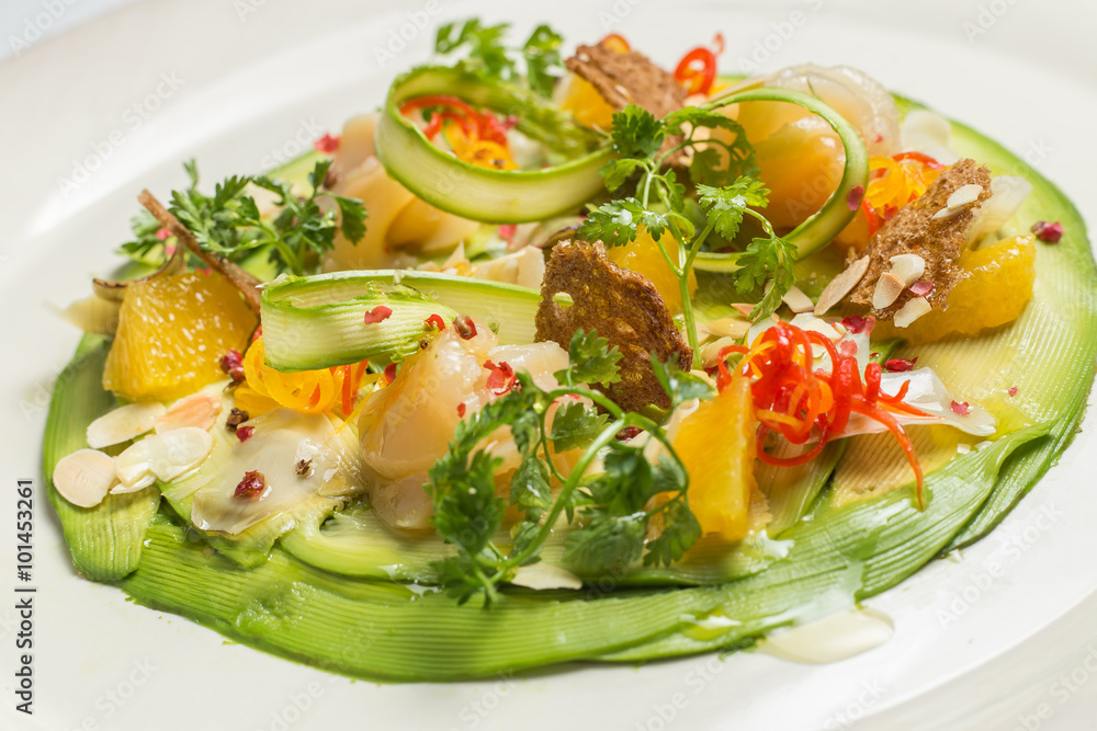 Carpaccio of prawns with citrus sauce on a white background. Gourmet cuisine. Carpaccio of prawns with citrus sauce on a white background. Gourmet cuisine.