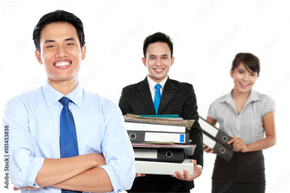 Fototapeta premium Young asian businessman, with his team behind. isolated in white