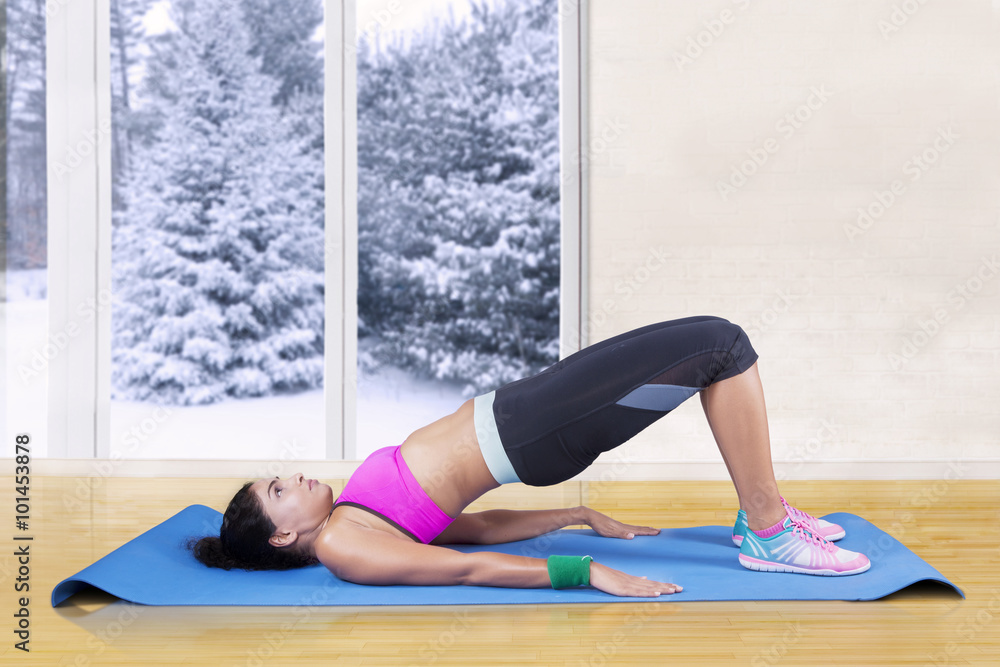 Woman doing bridge pose at home Woman doing bridge pose at home