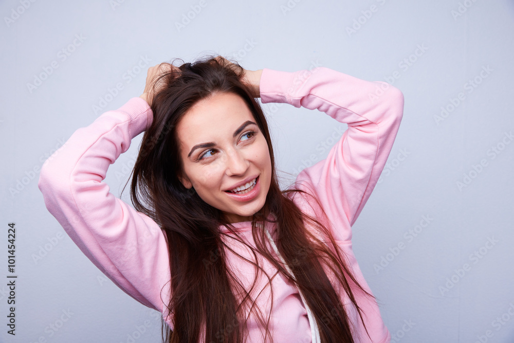 Naklejka premium beautiful brunette with straight hair pulls hair