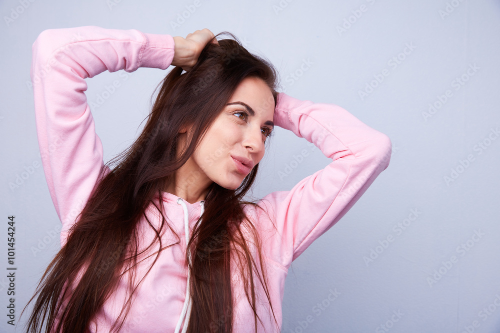 Obraz premium beautiful brunette with straight hair pulls hair