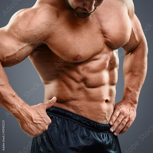 Man with torso muscles showing ok sign.