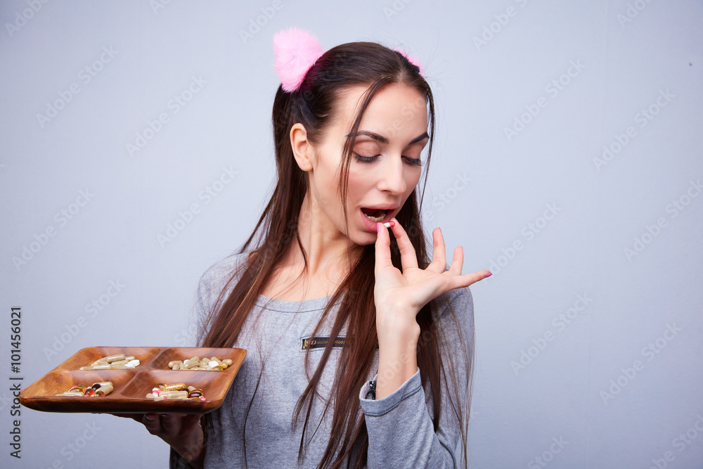 fun girl drinks a lot of pills