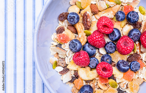 Healthy breakfast top view with text space.Bowl with cereals and berries.