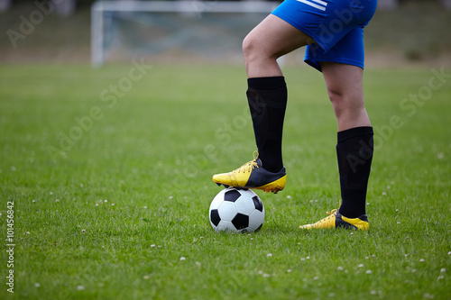 Fototapeta Naklejka Na Ścianę i Meble -  Football player with ball on field of stadium 