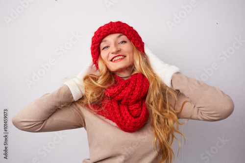 blonde in a red hat and scarf smiling © photoniko