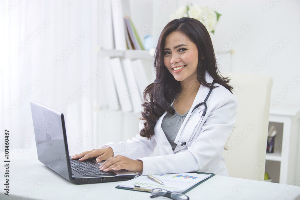 smiling doctor female working in her office smiling doctor female working in her office