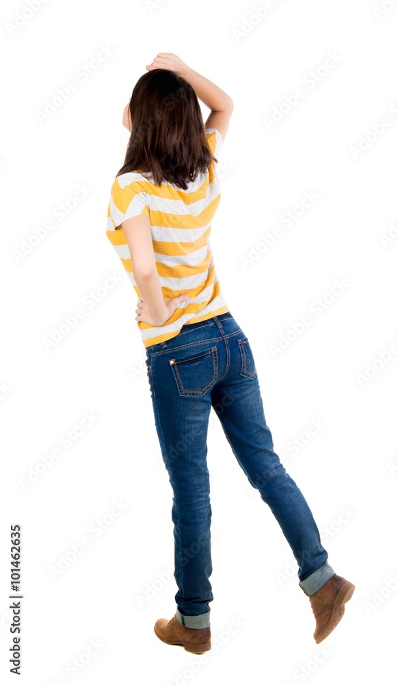 back view of standing young beautiful brunette woman in yellow back view of standing young beautiful brunette woman in yellow