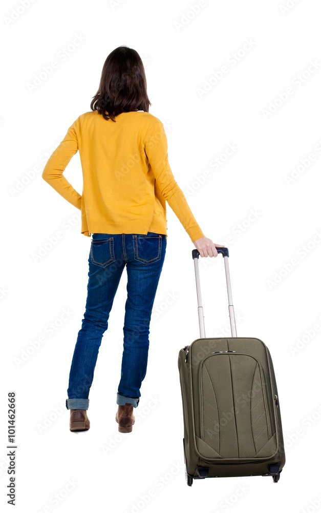 back view of walking woman in cardigan with suitcase. back view of walking woman in cardigan with suitcase.