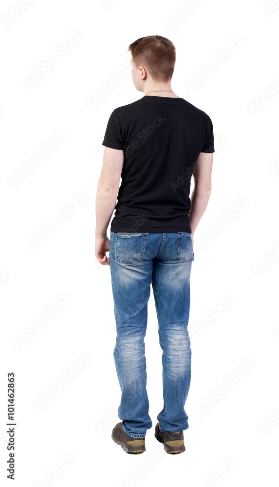 Back view of man in jeans. Standing young guy. Back view of man in jeans. Standing young guy.