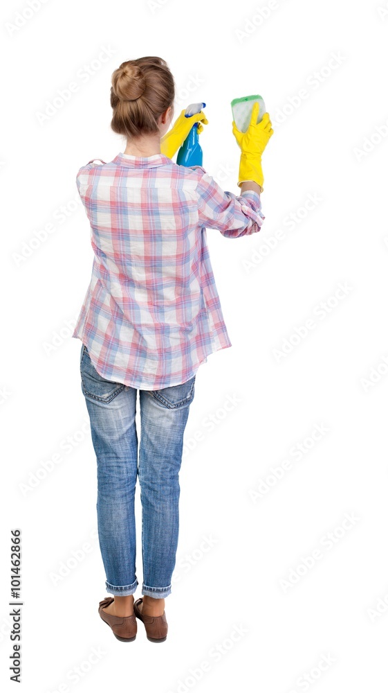 Back view of a housewife in gloves with sponge and detergent Back view of a housewife in gloves with sponge and detergent