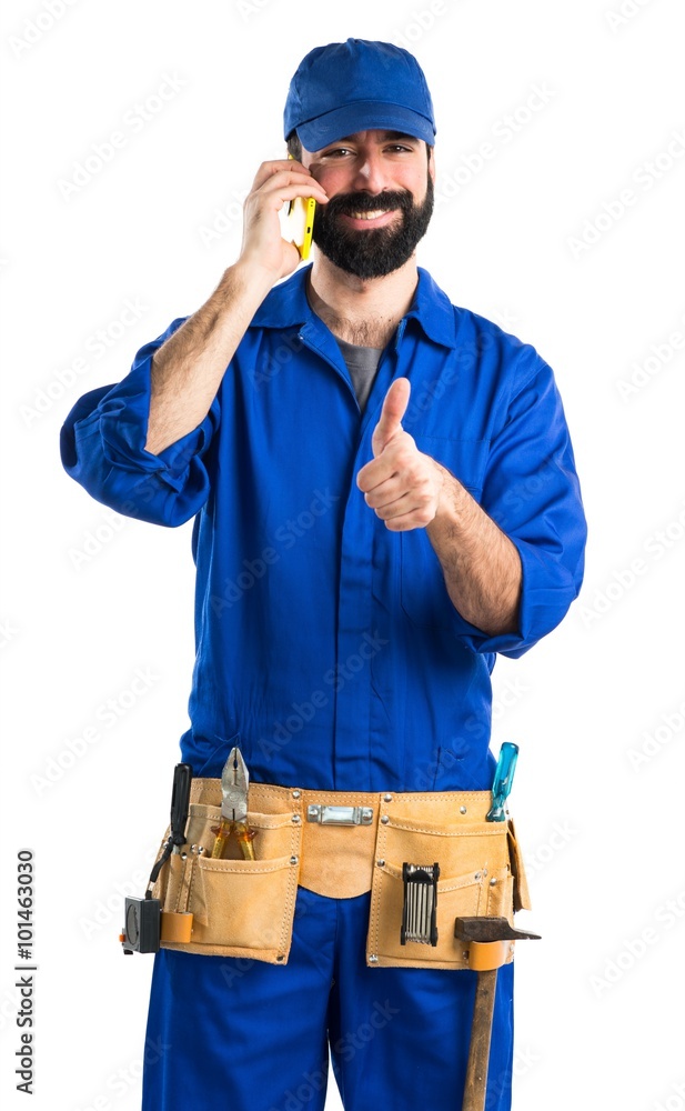 Plumber talking to mobile Plumber talking to mobile