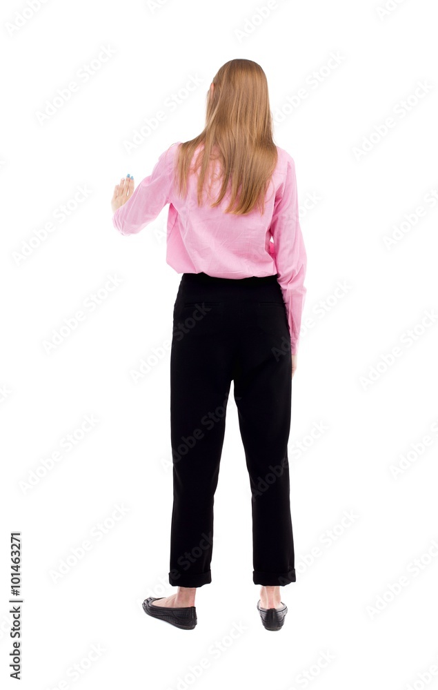 back view of young business woman presses down on something. back view of young business woman presses down on something.