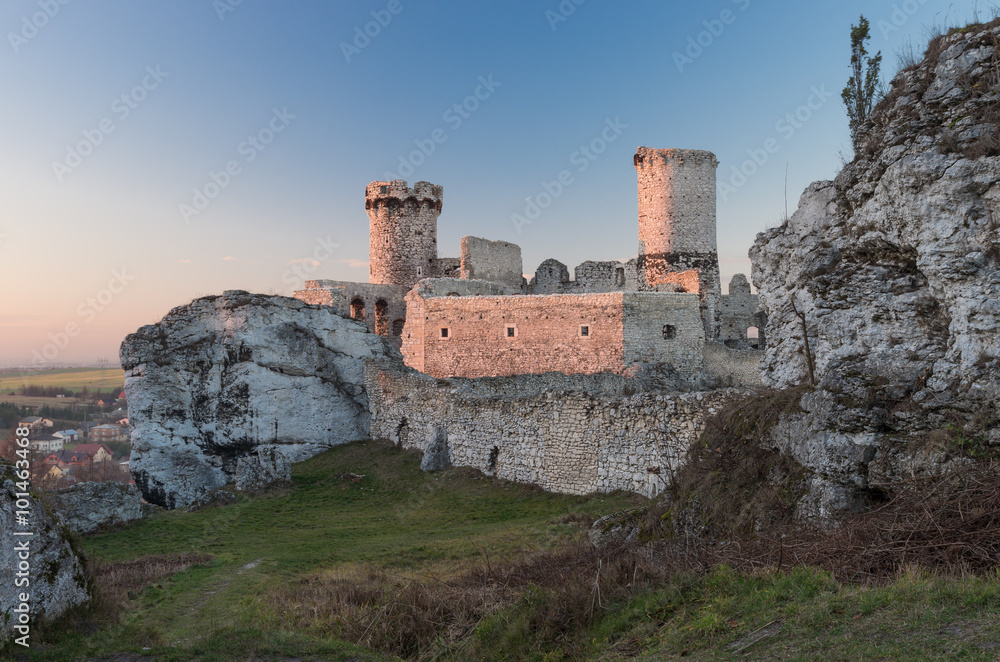Ruins of medieval castle in Ogrodzieniec, Poland, beautifully illuminated by the sun during sunset