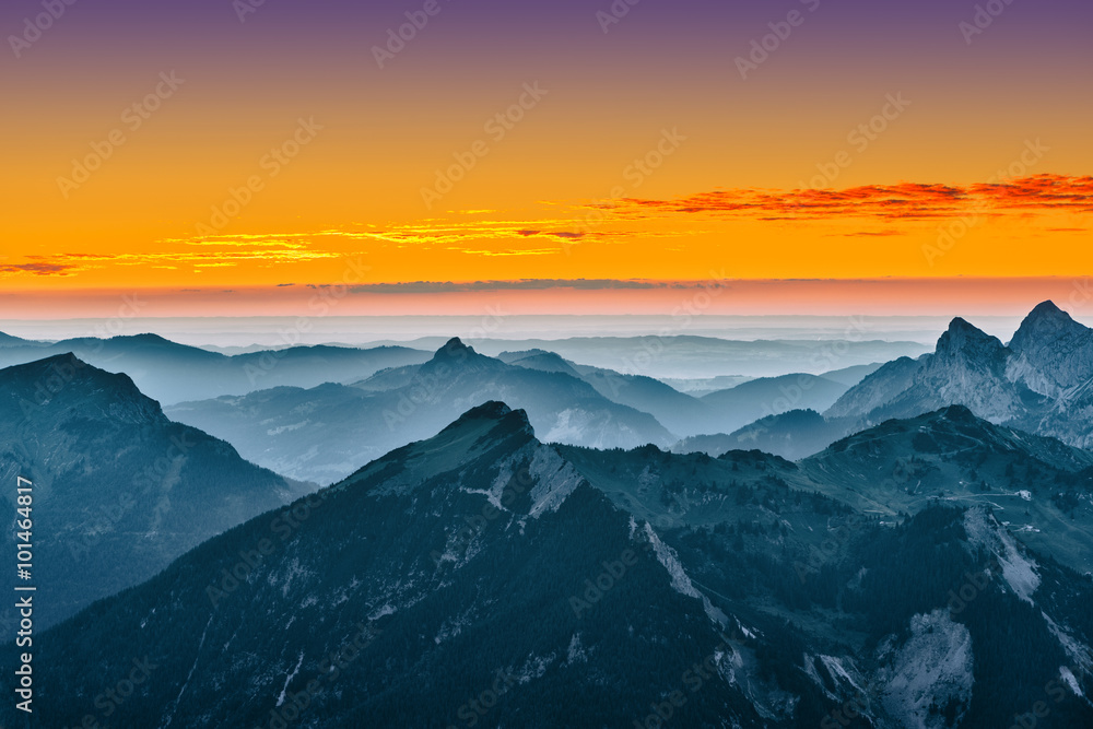view over blue mountains with golden yellow sunset sky