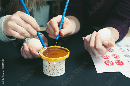 Decorating an Easter egg with wax