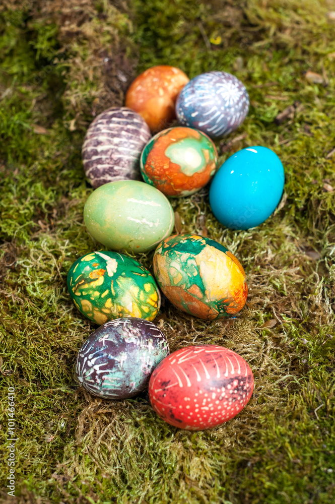 Fototapeta premium Colorful Easter eggs on the moss