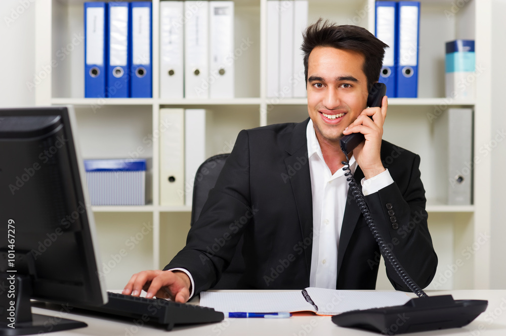Freundlicher Mitarbeiter berät am Telefon Freundlicher Mitarbeiter berät am Telefon