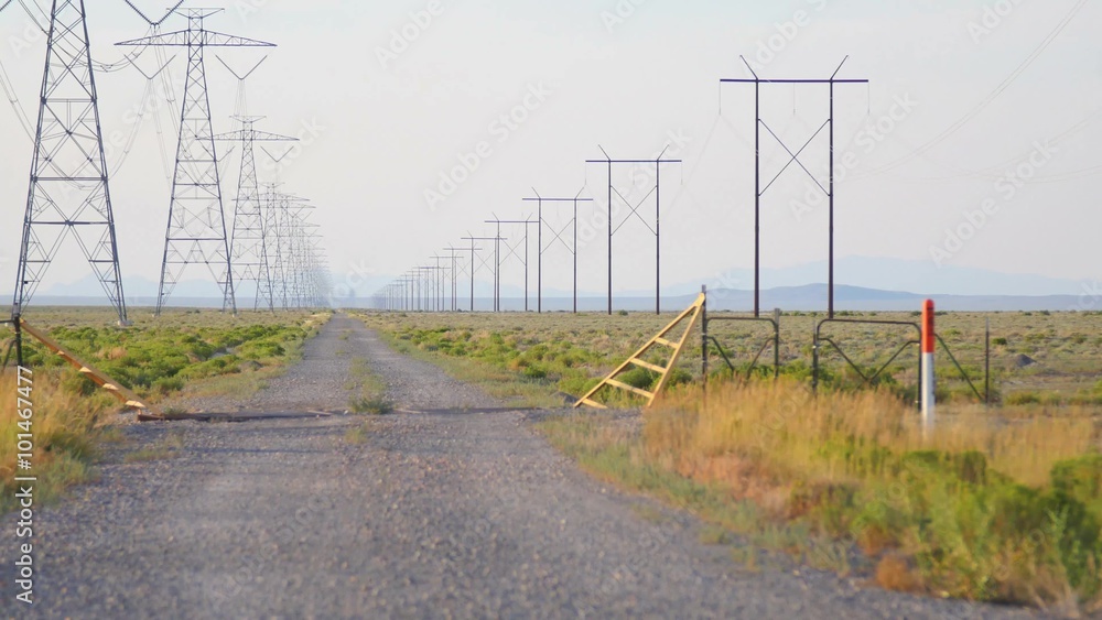 Power lines pierce the sky along a rural road. Power lines pierce the sky along a rural road.