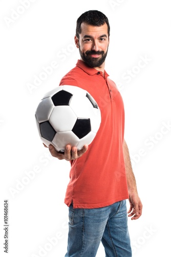 Handsome man holding a soccer ball © luismolinero