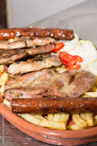 Grilled meat and sausages on the plate