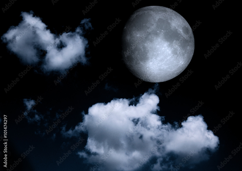 The moon in the night sky in clouds