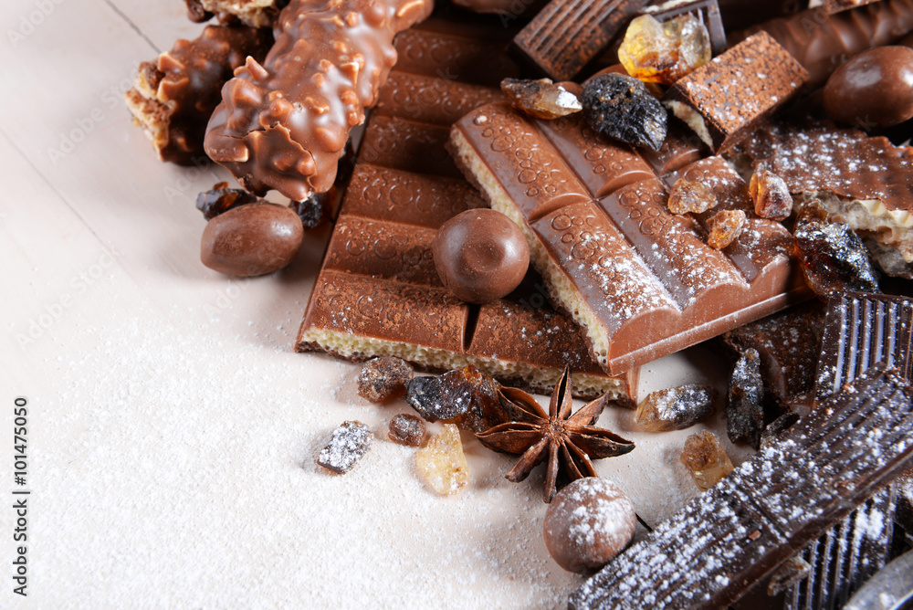 Chocolate sweets with powder on wooden background Chocolate sweets with powder on wooden background