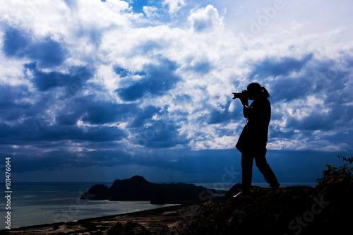 Woman silhouette standing on top of his photography.