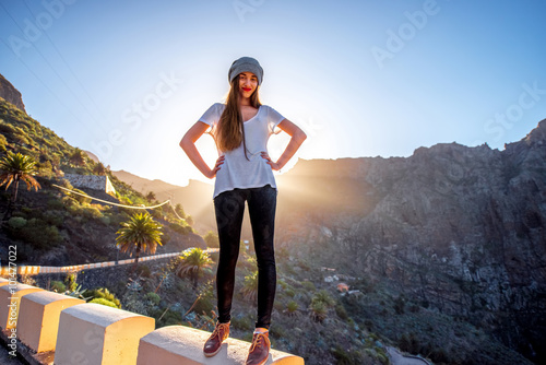 Woman standing on the mountain roadside