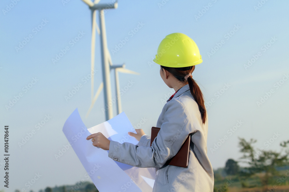 portrait women asia engineer working and holding blueprints at wind turbine farm Power Generator Station portrait women asia engineer working and holding blueprints at wind turbine farm Power Generator Station