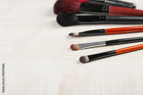 Makeup tools on a wooden background