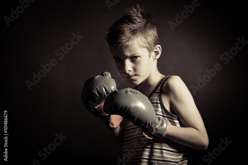Boxer Boy with Gloves Frowning at the Camera