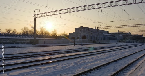 Panorama of Rails Empty Railway Station of Konotop City in Winter Wire Towers Buildings of a Station Snow on a Ground Sunset Clear Sky Ukraine