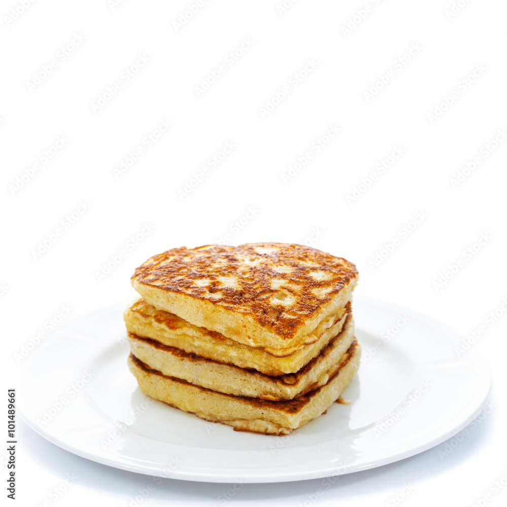 Pile of heart shaped pancakes on white plate Pile of heart shaped pancakes on white plate