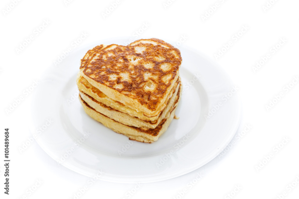 Pile of heart shaped pancakes on white plate Pile of heart shaped pancakes on white plate