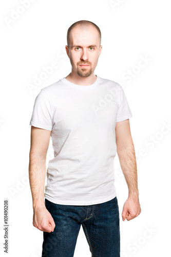Attractive bald bearded man with clenched fists in white t-shirt and jeans isolated on white