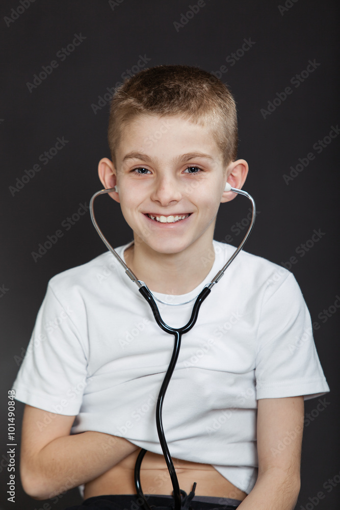 Smiling Boy Checking his Heart with Stethoscope Smiling Boy Checking his Heart with Stethoscope