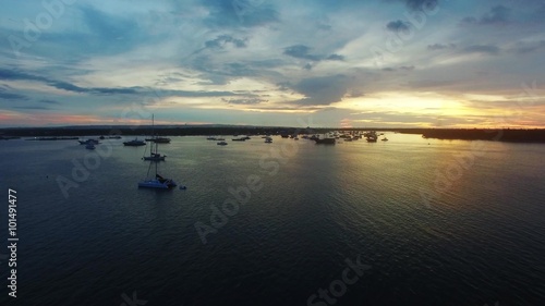 Aerial view of Bali at sunset. Popular summer beach in Indonesia with indian ocean and view on the bay with yachts