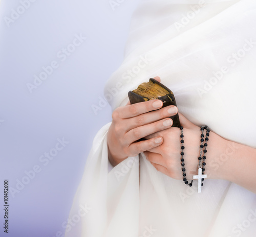 Young woman's hands with a rosary and a bible photo