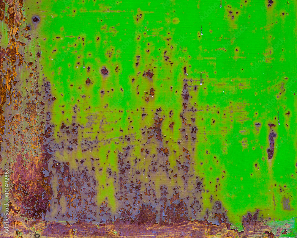 Rusty painted metal with cracked paint. Orange, brown and green