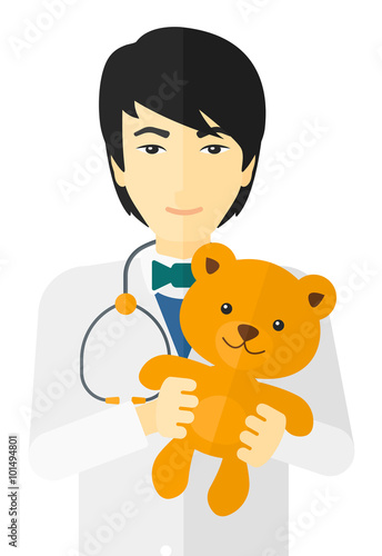 Pediatrician holding teddy bear.