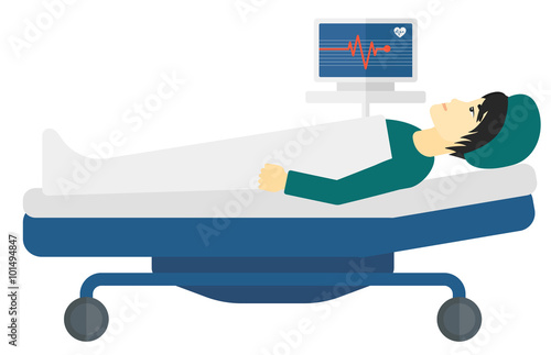Patient lying in bed with heart monitor.