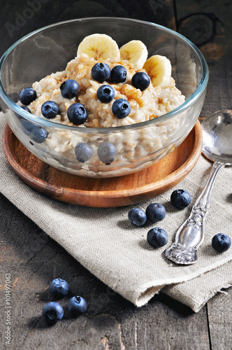 Oatmeal or porridge with blueberries and brown sugar. Healthy breakfast, toned image