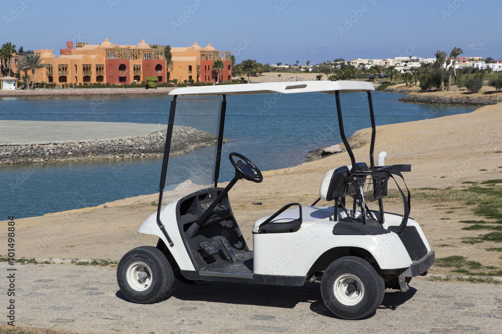 Golf carts on the canal bank. El Gouna. Egypt.