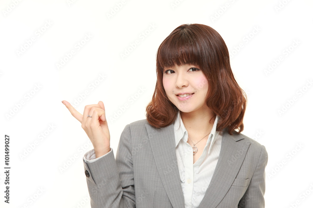 young Japanese businesswoman presenting and showing something young Japanese businesswoman presenting and showing something