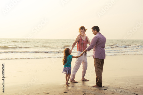Mixed race family having rest on the beach