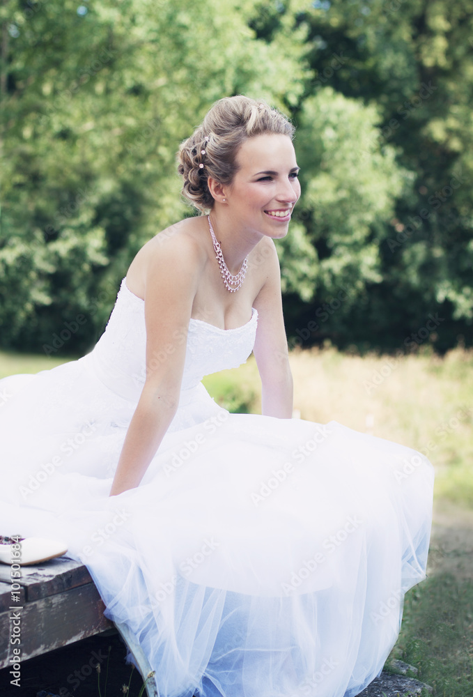 Bride sitting at the park after wedding celebration Bride sitting at the park after wedding celebration