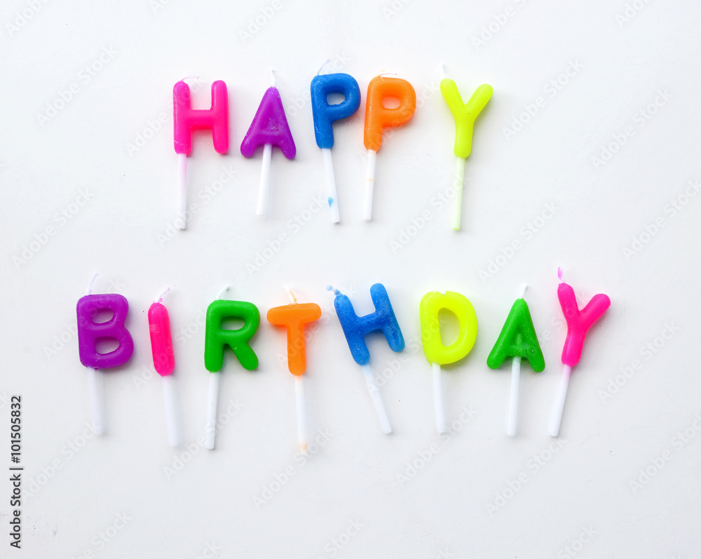 Colorful candles in letters saying Happy Birthday