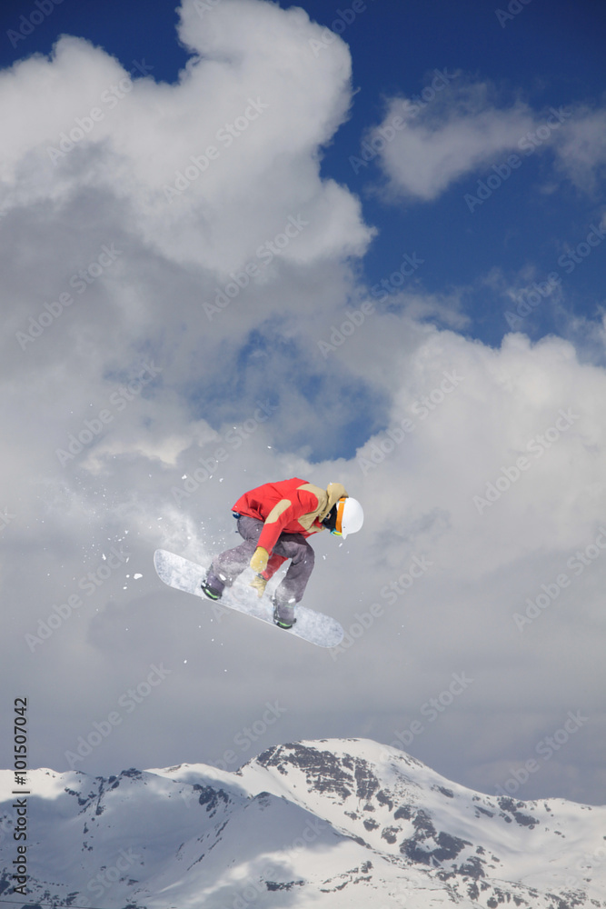 Flying snowboarder on mountains. Extreme sport.