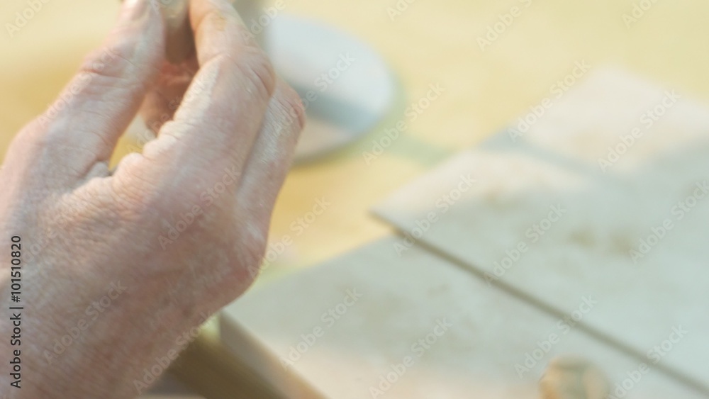 Male Hands Are Sculpting a Detail to a Clay Cat Statuette from a Clay and Going to Fix It Man is Working at the Table Hands Close Up Pottery Workshop Male Hands Are Sculpting a Detail to a Clay Cat Statuette from a Clay and Going to Fix It Man is Working at the Table Hands Close Up Pottery Workshop
